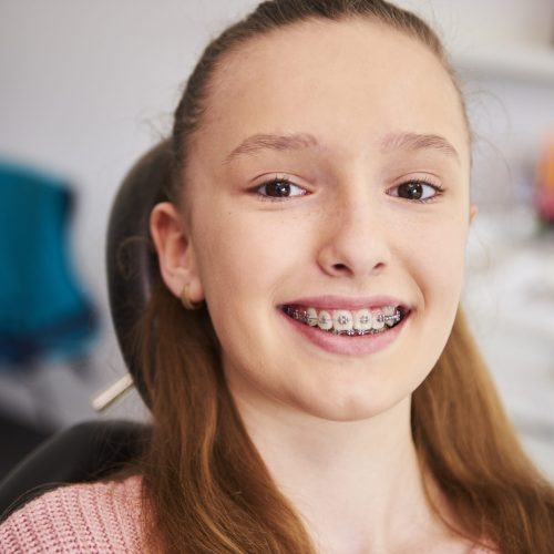 Portrait of smiling child with braces in dentist's office